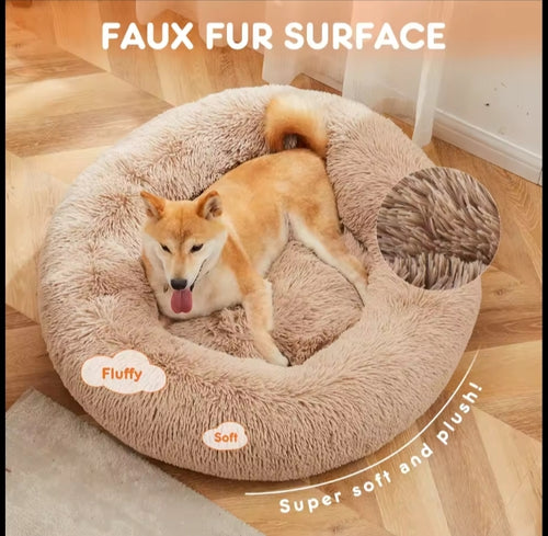 Shiba Inu resting on the tan calming donut dog bed, with a close-up of the soft faux fur surface