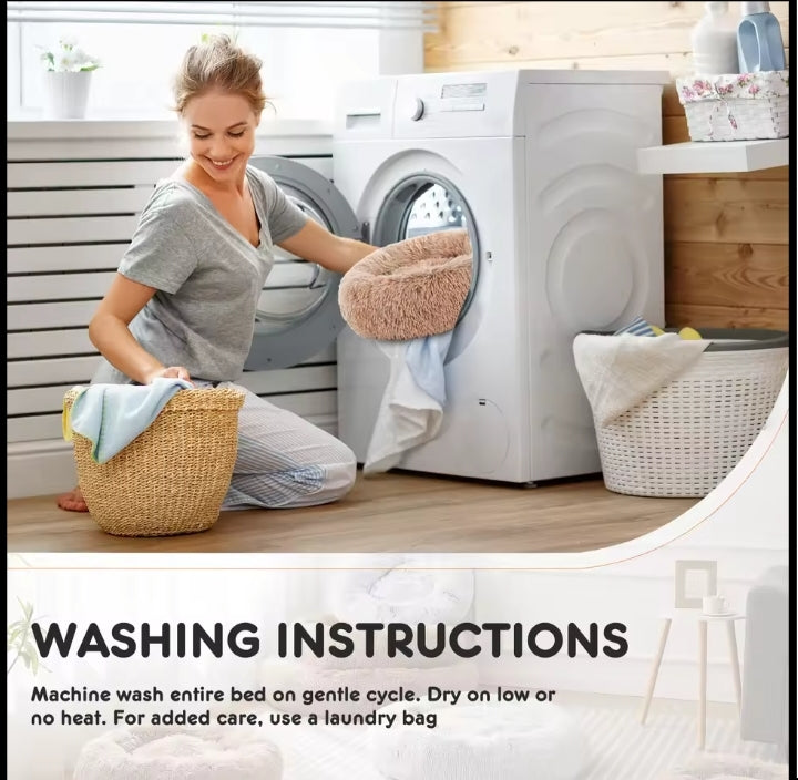Donut dog bed going into a washing machine; machine wash on a gentle cycle, dry on low or no heat